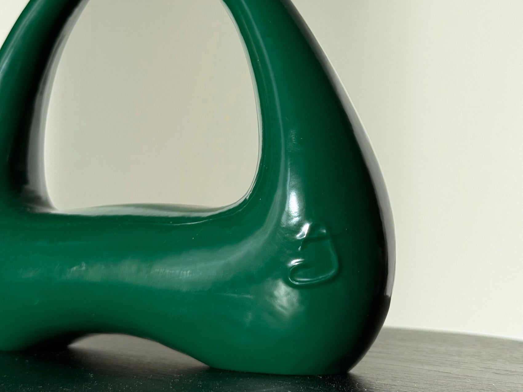 detail of forest green kettlebell atomya logo closeup