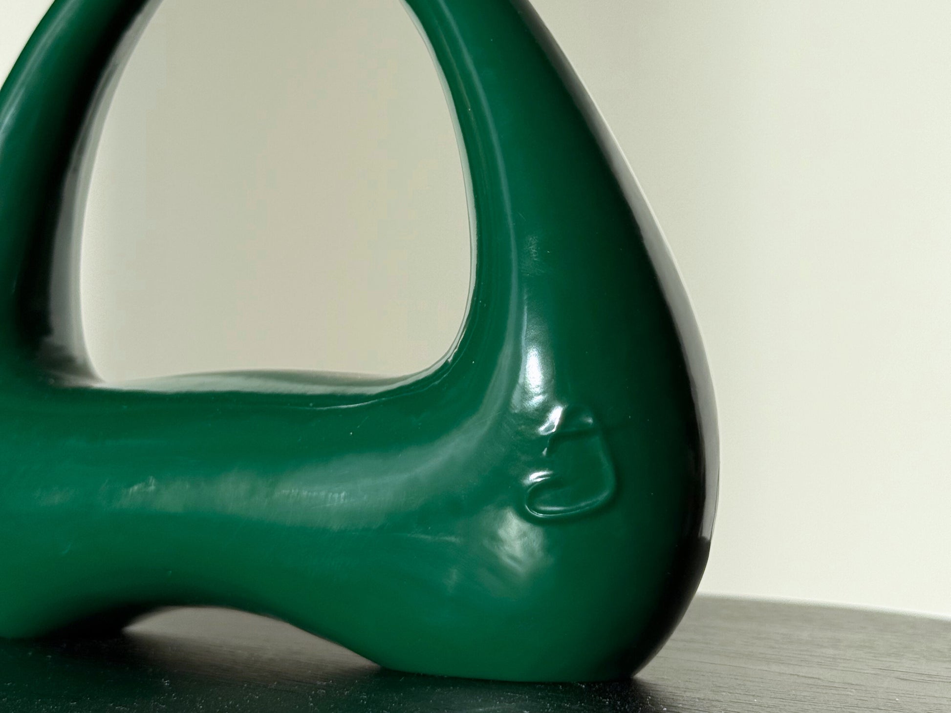 detail of forest green kettlebell atomya logo closeup
