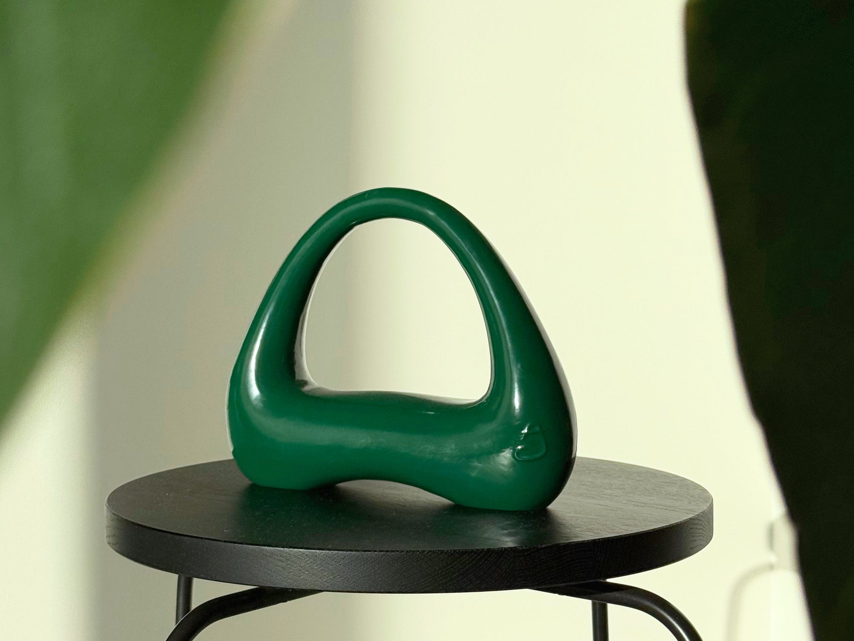 forest green kettlebell atomya on table